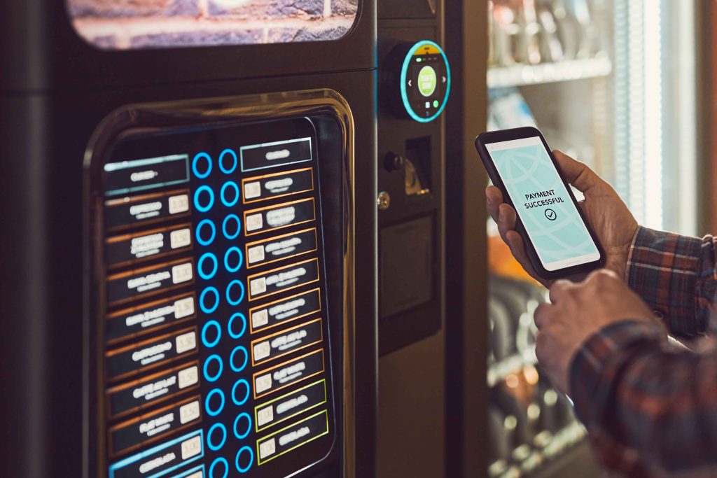 consumer paying for product at vending machine usi 2023 11 27 05 12 49 utc 1